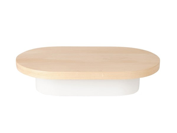 A shallow, oval-shaped white metal base container with a flat maple wood top sits on a white background. The wooden lid slightly overhangs the edges, giving it a minimalist and modern appearance.