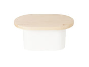 A small container with a white metal base and a flat, oval-shaped maple wood top. The minimalist design contrasts the smooth, opaque white body with the natural grain and pale color of the wood. The background is plain white.