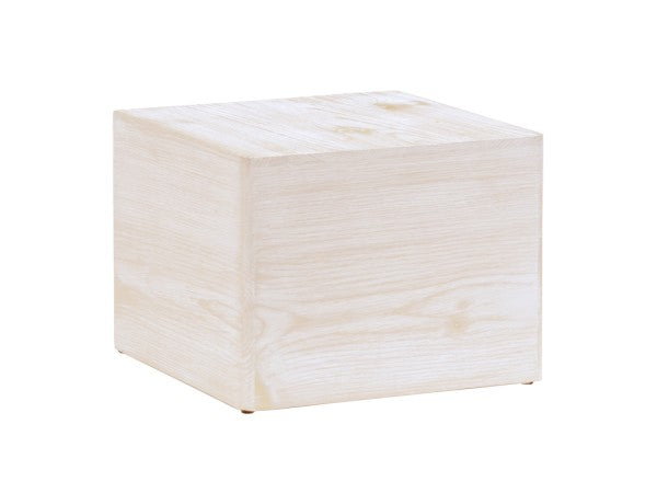 A simple, light Newport cube riser with a smooth surface and subtle wood grain pattern sits on a white background. The sharp edges, clean lines, and white-washed pine wood finish give it a minimalist, modern appearance.