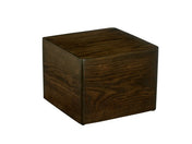 A dark brown wooden Cal-Mil Heritage Riser cube, 12" x 12" x 9"H, with smooth edges and visible wood grain patterns, is positioned on a plain white background. The cube appears solid and serves as a minimalist table or stool.