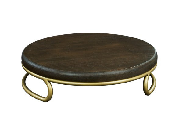 A round, dark stained oak top forms the surface of this Heritage Riser, elevated by three short matte gold wire base legs that curve outward in a decorative loop design for a simple, modern look.