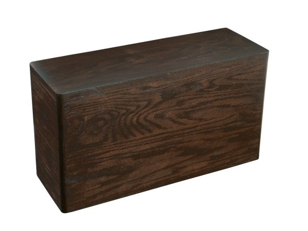 A dark stained oak Heritage Riser rectangle yoga block with visible wood grain patterns, shown against a white background. The block has smooth, rounded edges and corners, giving it a polished appearance.