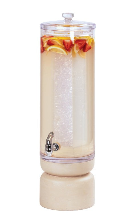 A tall, clear 3-gallon Beverage Dispenser with a domed lid is filled with a pale drink, ice, and pieces of strawberries and lemon slices. It features a metal spigot near the base and sits on a round, light-colored stand.