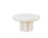 A modern, round coffee table with a smooth, white-washed pine finish. The tabletop is supported by six cylindrical legs arranged close together in a circular pattern, giving this Newport-inspired piece a sturdy and sculptural pedestal riser appearance. The background is plain white.