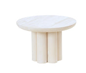 A round, light coffee table crafted from white-washed pine wood with a smooth top and a base of thick cylindrical legs grouped closely together, inspired by Newport style and set against a plain white background.