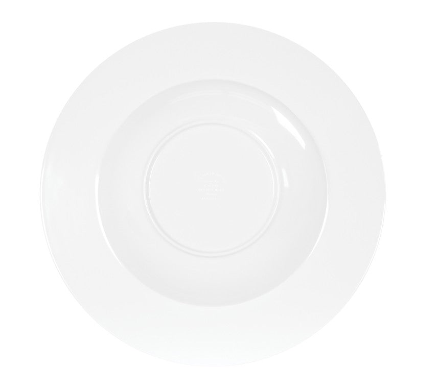 A plain, white, round porcelain plate seen from above on a white background. The empty plate features a shallow central area with a wide, smooth rim, resembling the minimalistic design of a classic white rimmed bowl.