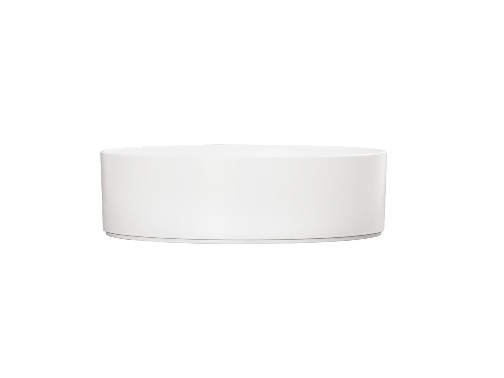 A simple, round Hudson Bowl with straight sides is centered on a plain white background. This minimalistic, white ceramic bowl has no visible decorations or handles and is dishwasher safe for easy cleaning.