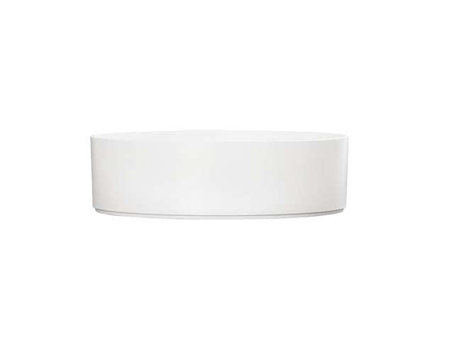 A simple, round Hudson Bowl with straight sides is centered on a plain white background. This minimalistic, white ceramic bowl has no visible decorations or handles and is dishwasher safe for easy cleaning.