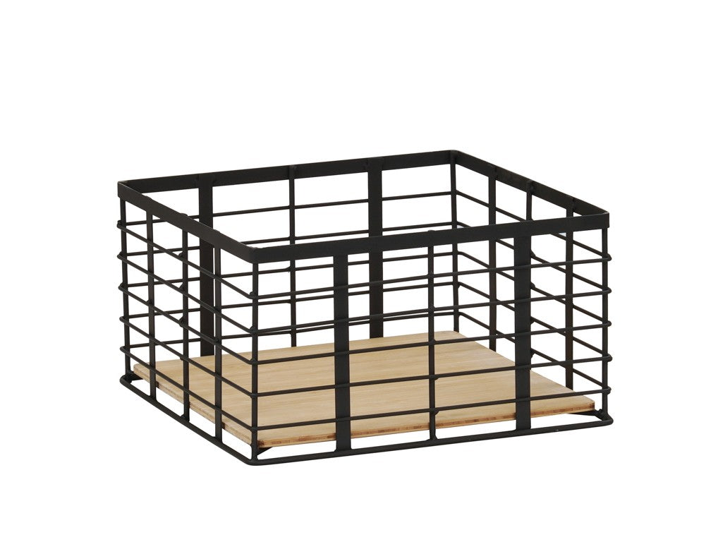 A square storage basket with a black metal wire frame and an open top. The flat, light-colored wooden base features a reversible design. This minimalist and modern basket is perfect for organizing items in Madison-inspired homes or offices.