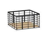 A square storage basket with a black metal wire frame and an open top. The flat, light-colored wooden base features a reversible design. This minimalist and modern basket is perfect for organizing items in Madison-inspired homes or offices.