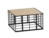 A small, square Madison riser with black metal grid sides and base, topped with a flat, light wood panel. Its minimalist, industrial-style container features a reversible design for versatile storage or display options.