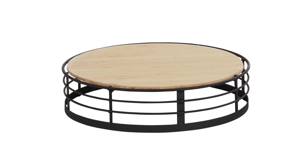 The Madison round coffee table features a light wooden top and a black metal base with three horizontal circular bars, creating an open, airy design. Its reversible design adds versatility, making it both stylish and functional against any white backdrop.