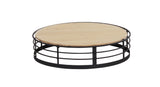 The Madison round coffee table features a light wooden top and a black metal base with three horizontal circular bars, creating an open, airy design. Its reversible design adds versatility, making it both stylish and functional against any white backdrop.