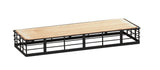 A rectangular riser with a wooden top and black metal grid frame, shown against a white background. The open grid sides and base support the smooth, light wood surface, creating a modern, minimalist look with reversible design for versatile display.