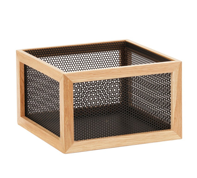 A square storage box with a light wooden frame and black metal mesh sides and bottom, featuring a fine, grid-like mesh. The Camden box has a reversible design for versatile use and is empty, shown on a white background.