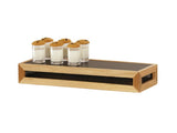 A rectangular Camden wooden tray with a riser and black center holds six small glass cups, each filled with milk and topped with a chocolate chip cookie. The tray features open sides with mesh detail against a plain white background.