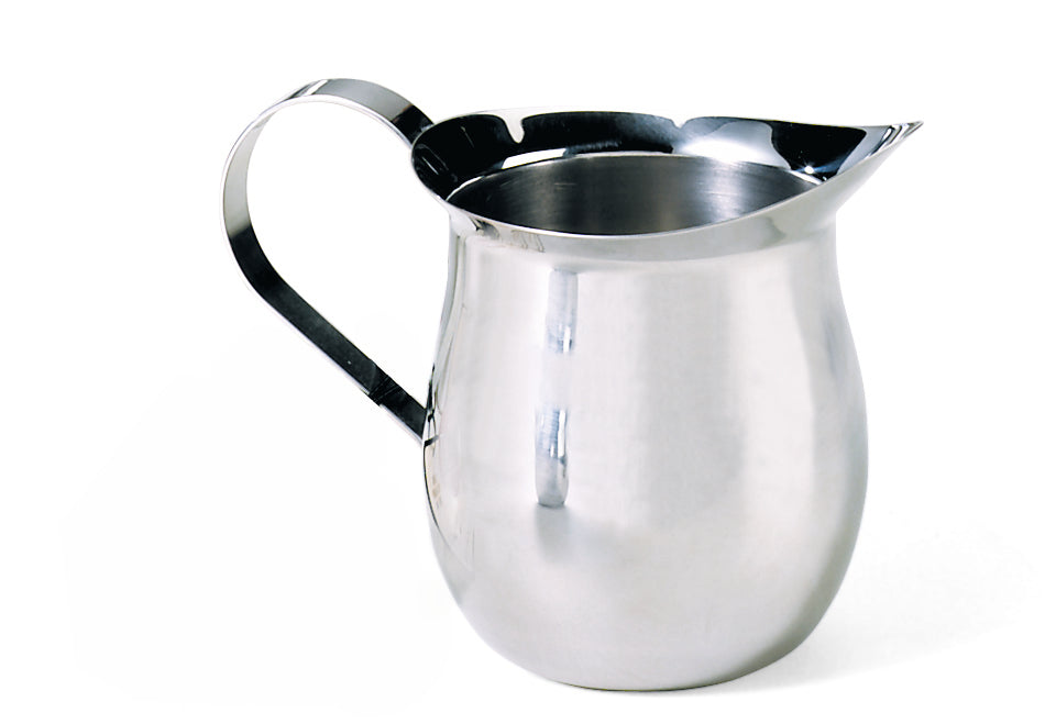 A shiny stainless steel Bell Creamer pitcher with a curved handle and wide spout sits on a white background. The pitcher has a rounded body, a reflective surface, and is dishwasher safe, with no visible markings or decorations.
