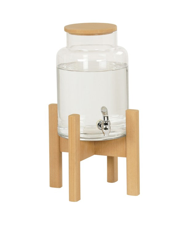 A clear glass water dispenser with a wooden lid sits on a light wood stand. Perfect for beverage display, it features a silver spigot for easy pouring. The simple, modern design uses natural materials for a stylish touch.