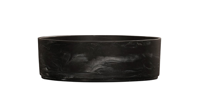 A sleek, round black marble bowl sink basin with subtle white veining. The vessel has smooth sides and a flat base, giving it a modern, minimalist appearance. The plain white background highlights the basin’s dark, elegant surface.