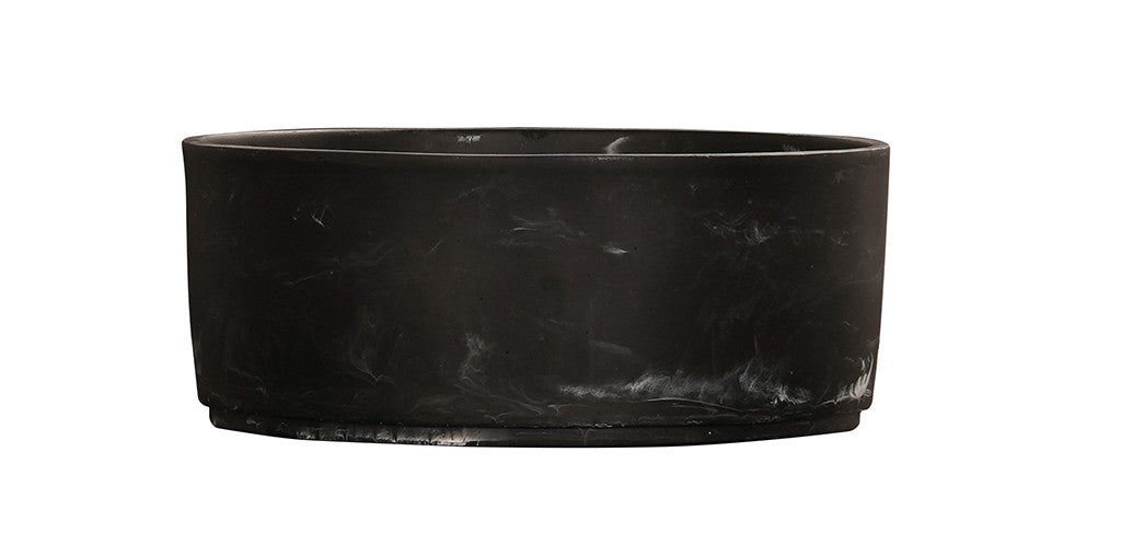 A black marble bowl with straight sides and a flat base, crafted from smooth matte resin featuring subtle white marbling. Its minimalist design gives it a sleek, modern appearance against the white background.