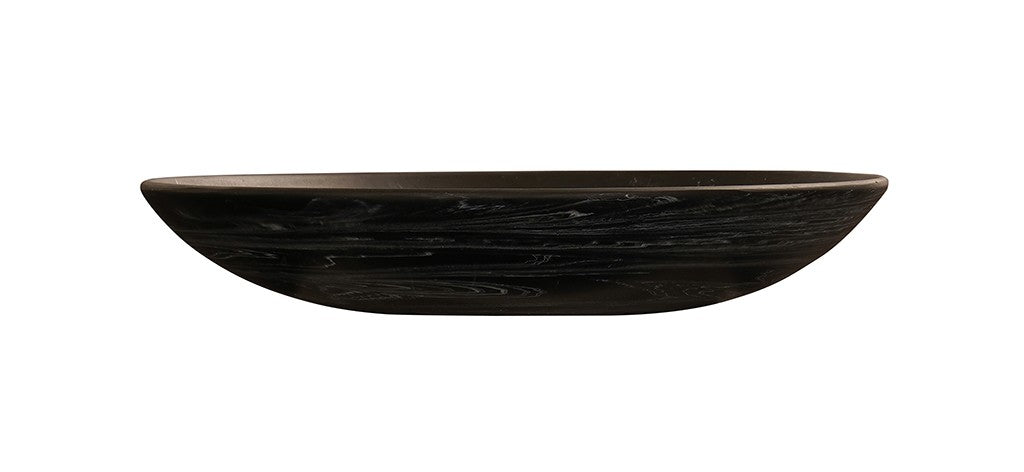 A shallow, oval-shaped resin bowl with a smooth, matte finish and subtle black marble swirling patterns. Set against a plain white background, it’s viewed from the side, highlighting its gently curved form and thin rim.
