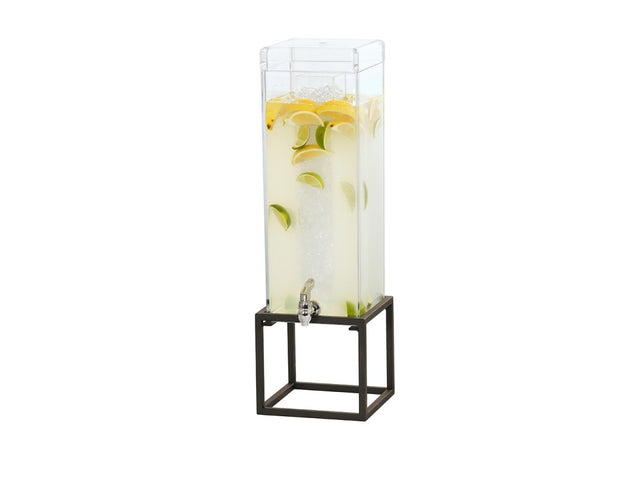 A tall, clear Ice Beverage Dispenser with a square polycarbonate chamber is filled with lemonade, ice, lemon, and lime slices. It has a spigot near the bottom and sits on a black open metal stand against a plain white background.