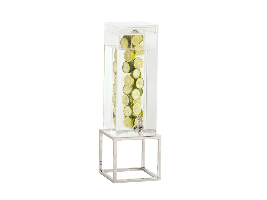 A tall, clear Infusion Beverage Dispenser with a polycarbonate chamber filled with water and lime slices stands on a geometric silver stand with a chrome plate finish. A small front spigot dispenses the drink. The background is plain white.