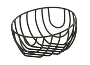 A black wire fruit bowl, like the Cal-Mil Madison Wire Basket, features an open, geometric design. This oval-shaped basket is made of curved metal rods for a modern, minimalist look against a plain white background.
