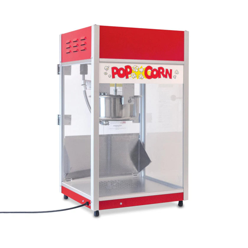 A red and silver popcorn machine with an 8 oz kettle and glass sides sits on a white countertop. “Popcorn” is written in colorful letters on the front panel, decorated with popcorn illustrations. The serving tray and power cord are visible inside.
