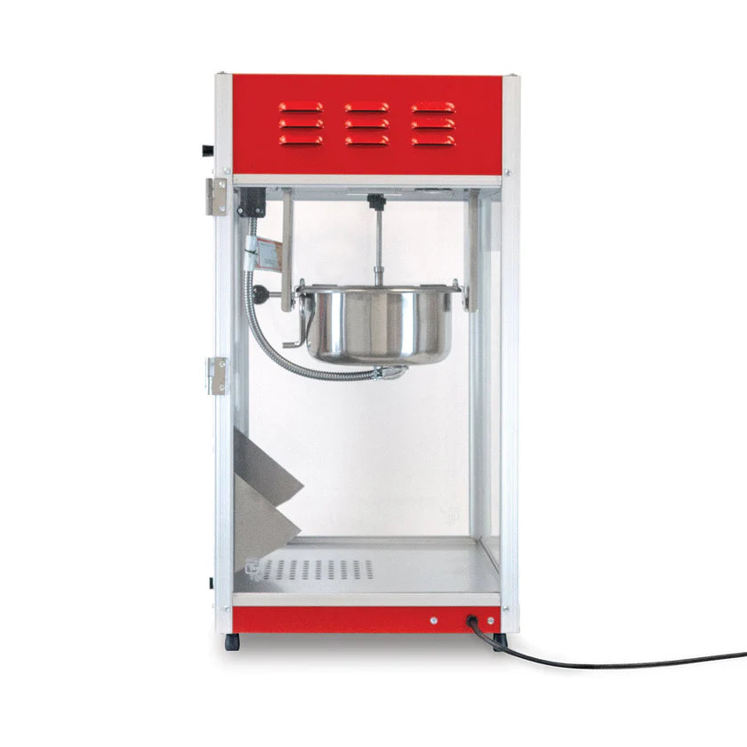 A red and silver countertop popcorn machine with a glass enclosure, 8 oz kettle inside, hinged glass door on the left, and a black power cord extending from the bottom right. The interior is empty and clean.