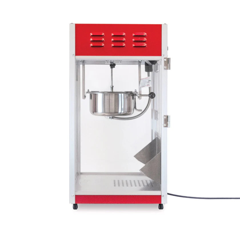 A red and silver countertop popcorn maker with a glass front, metal 8 oz kettle, and a door on the right. The electric cord extends from the bottom right side. Inside, it features a stirring kettle and stainless steel tray for catching popcorn.