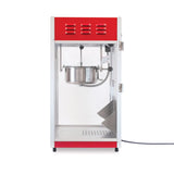 A red and silver countertop popcorn maker with a glass front, metal 8 oz kettle, and a door on the right. The electric cord extends from the bottom right side. Inside, it features a stirring kettle and stainless steel tray for catching popcorn.