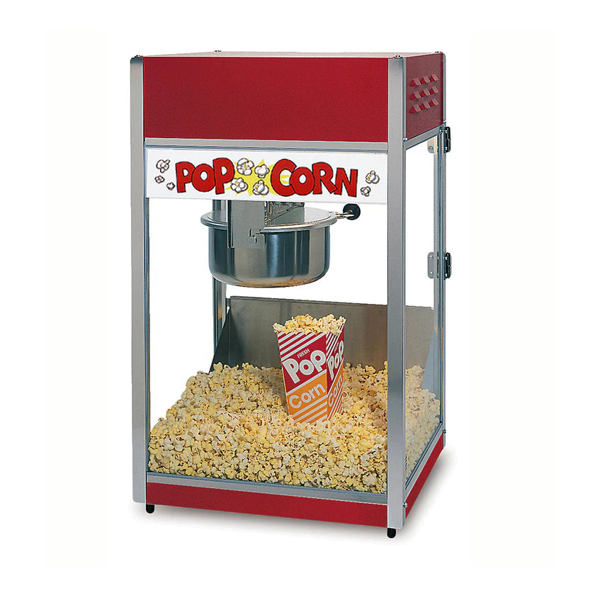 A red and silver popcorn machine with a countertop design features an 8 oz kettle filled with popped popcorn. Inside the glass case, a striped "Pop Corn" container sits among the treats, beneath a white sign with red letters and yellow popcorn illustrations.