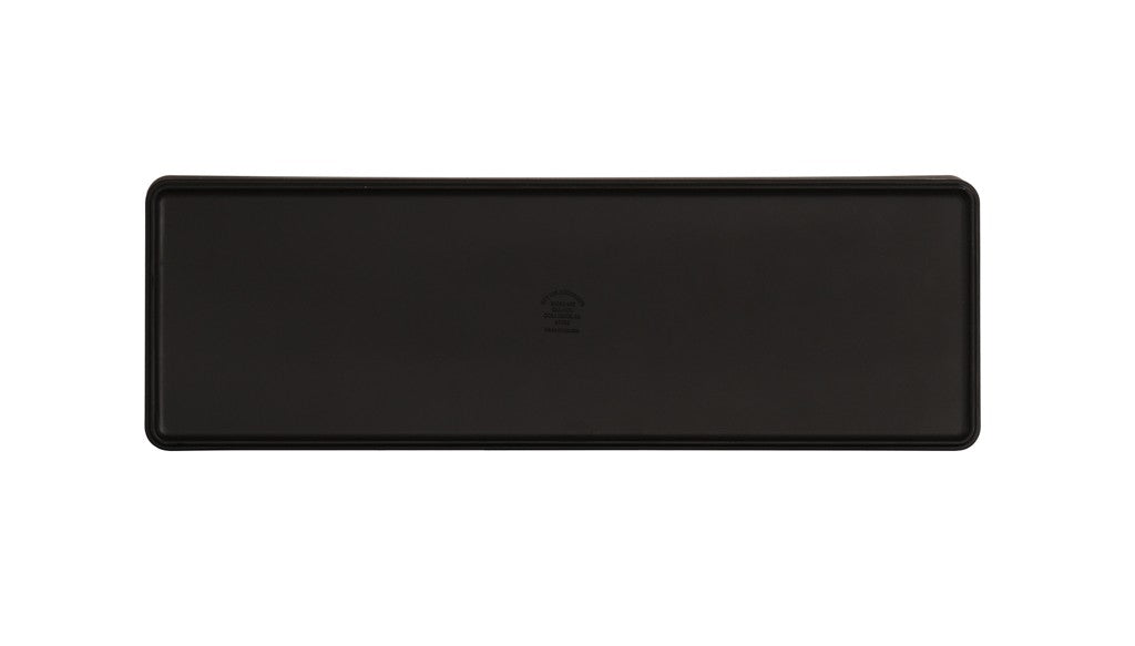 A rectangular, black plastic tray with slightly raised edges is shown from above. The smooth surface features a subtle embossed symbol in the center. Dishwasher safe, the tray’s shape and design stand out against the white background.