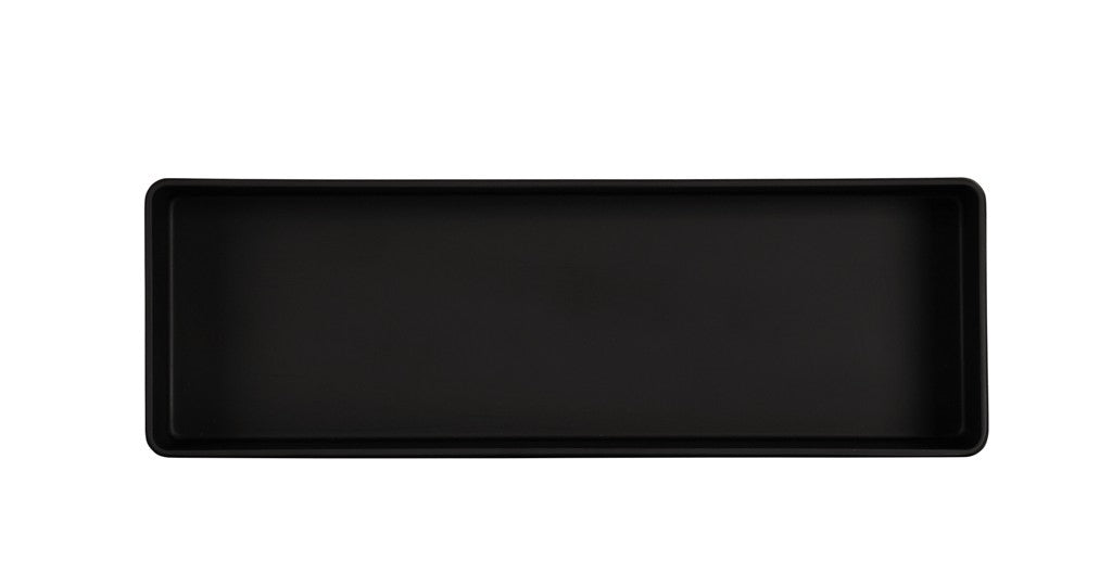 A rectangular, black, shallow tray with raised edges viewed from above. The matte-finished Hudson Bowl is empty and set against a plain white background. This piece is dishwasher safe for convenient cleaning.