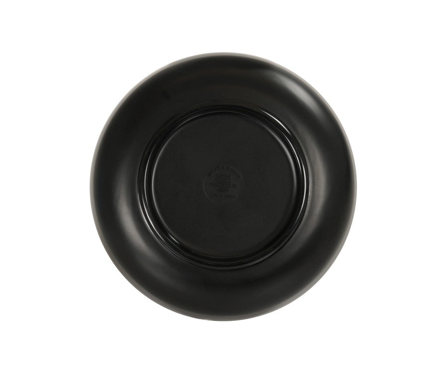 A black round melamine bowl, shown from below on a white background. The plate has a raised circular base with a faint maker’s mark in the center, though the text is not clearly legible. The Oslo Bowl is dishwasher safe with smooth, evenly curved edges.