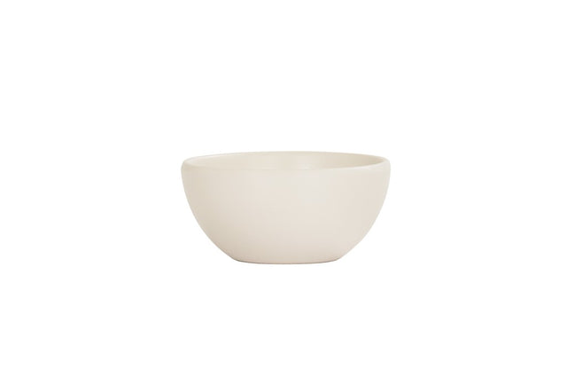 A plain, round, off-white Oslo Bowl is centered on a white background. The bowl has a smooth, matte finish and gently curved sides, with no visible patterns or decorations. This melamine bowl is also dishwasher safe for easy cleaning.