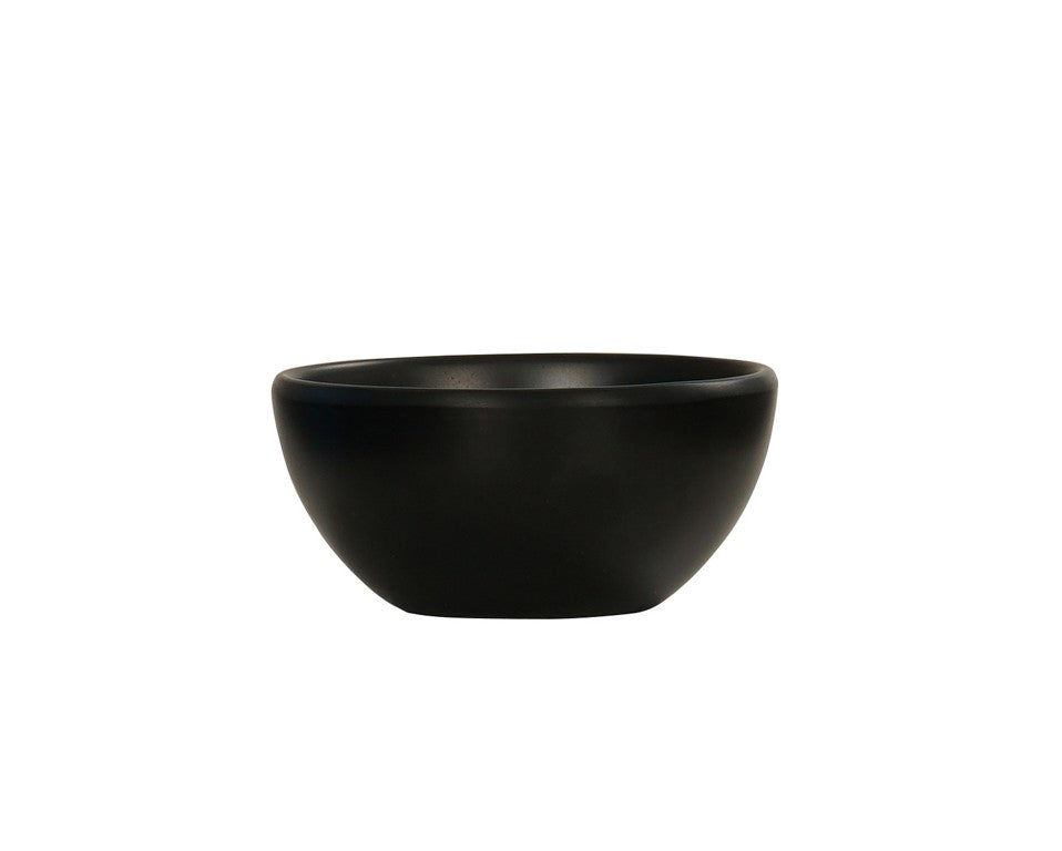 A small, matte black Oslo Bowl with a smooth, rounded shape sits centered on a plain white background. This minimalist melamine bowl is dishwasher safe and features no visible patterns or decorations.