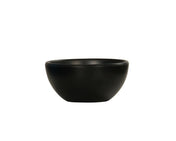 A small, matte black Oslo Bowl with a smooth, rounded shape sits centered on a plain white background. This minimalist melamine bowl is dishwasher safe and features no visible patterns or decorations.