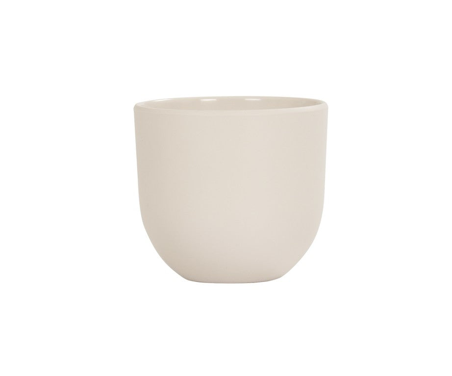 A plain, round, light beige ceramic cup with smooth sides and no handle, set against a white background. Featuring a simple, minimalist design and a slightly curved bottom, this Oslo Bowl-inspired cup is also dishwasher safe for easy cleaning.