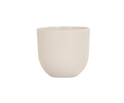 A plain, round, light beige ceramic cup with smooth sides and no handle, set against a white background. Featuring a simple, minimalist design and a slightly curved bottom, this Oslo Bowl-inspired cup is also dishwasher safe for easy cleaning.