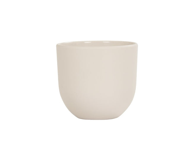 A plain, round, light beige ceramic cup with smooth sides and no handle, set against a white background. Featuring a simple, minimalist design and a slightly curved bottom, this Oslo Bowl-inspired cup is also dishwasher safe for easy cleaning.
