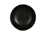 A round, matte black plate with slightly uneven edges is centered on a white background. With a smooth surface and minimalist, modern design, this dish is also dishwasher safe for easy cleaning.