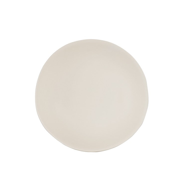 A plain, round, off-white ceramic plate with a slightly uneven, organic edge is centered on a white background. Its simple design and neutral color evoke a minimalist and modern look—perfect to pair with your favorite Hand Thrown Bowl.