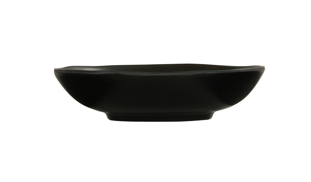 A shallow, round hand thrown bowl with slightly curved sides and a matte finish, viewed from the side against a plain white background. The bowl features smooth, clean lines and a small, raised base.