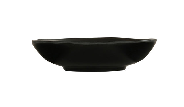 A shallow, round hand thrown bowl with slightly curved sides and a matte finish, viewed from the side against a plain white background. The bowl features smooth, clean lines and a small, raised base.