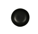 A plain, round, matte black ceramic plate with a slightly irregular edge is centered on a white background. The plate, reminiscent of a hand thrown bowl, is empty and features a modern, minimalist design.