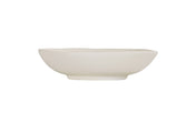 A plain, white, hand thrown bowl with smooth, gently curved sides and a slightly uneven rim sits on a white background. The minimalist, unadorned design gives this ceramic vessel a simple and modern appearance.