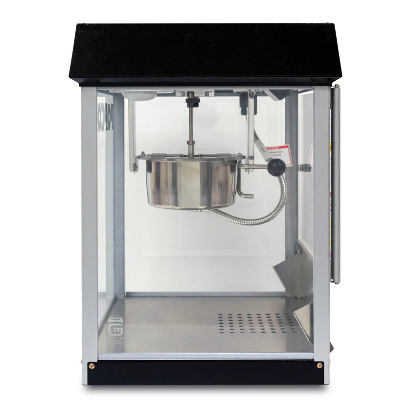 A countertop popcorn machine with a black top and base features a stainless steel kettle suspended inside. The clear front door and vented floor let you watch every batch as this stylish popcorn popper creates perfect snacks.