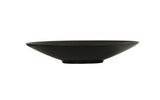 A shallow, wide, black ceramic Nomi Bowl with a slightly ribbed texture and a small circular base, photographed on a plain white background. The bowl's minimalist design gives it a modern and elegant appearance.